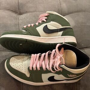 Air Jordan 1 Mid in a green/white colorway with custom pink laces